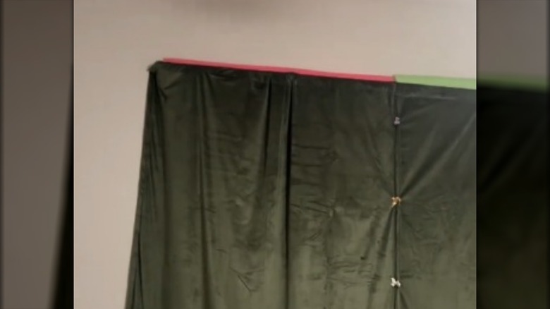 Blackout curtains with pool noodles used to block light from leaking in at the top