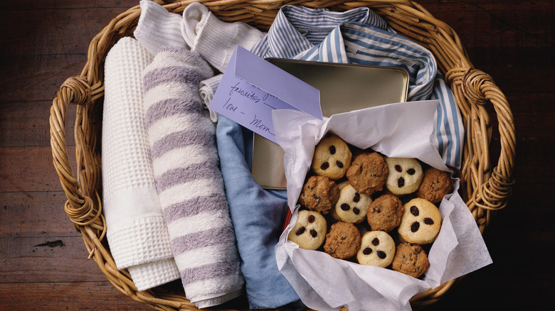 A welcome basket with towels, cookies, socks, and a shirt