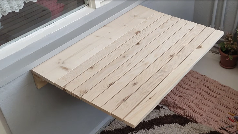 Foldable wooden table that extends from the wall