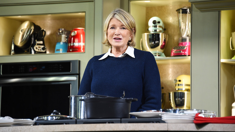 Martha Stewart in front of a pot cooking