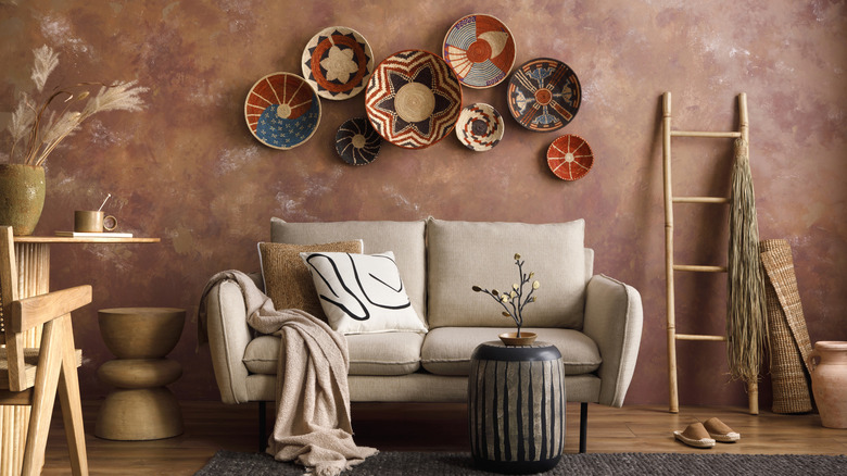 Boho living room with plates hung above sofa