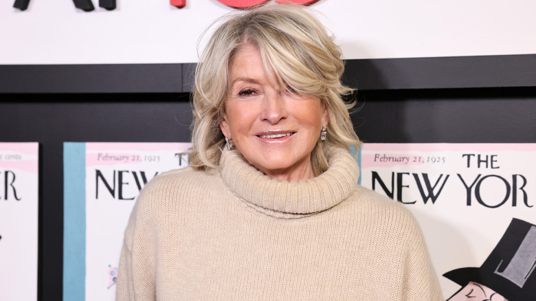 Martha Stewart smiles at a photo call while wearing a beige sweater