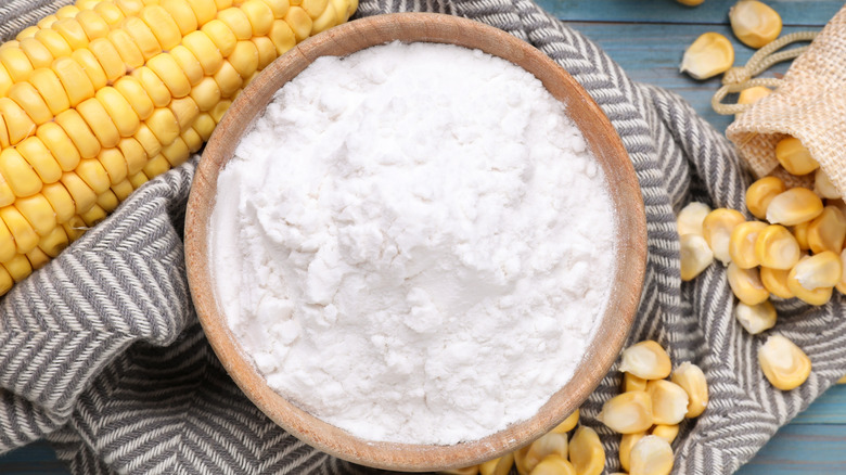 A bowl of cornstarch surrounded by corn