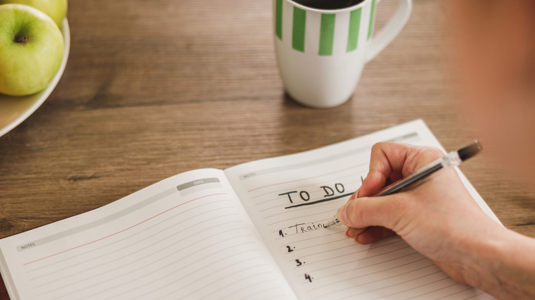 Person writing a to do list