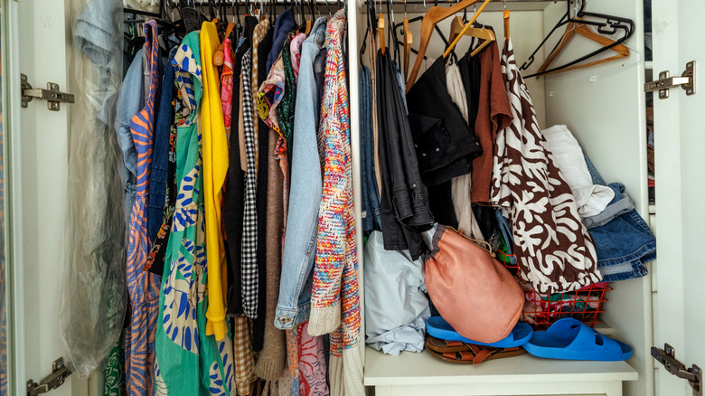 messy closet that is full of hanging storage