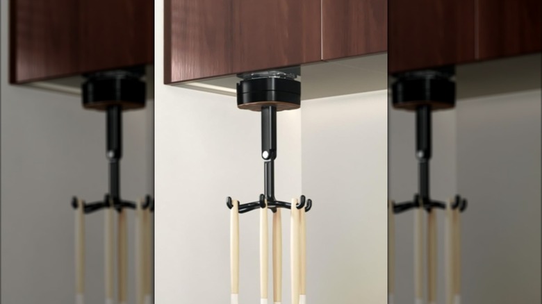 Hanging black swivel beneath dark wood cabinets with hanging cooking tools