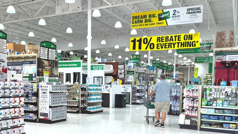 Man walking through brightly lit Menards store