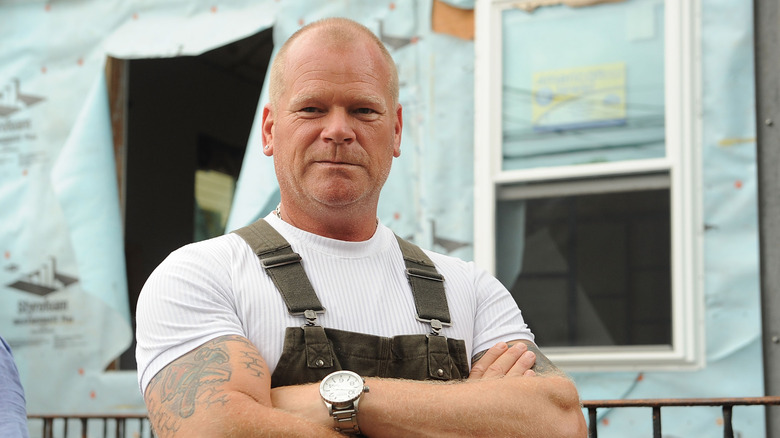 Mike Holmes standing with arms crossed