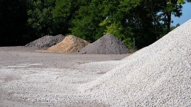 Multiple piles of gravel at a landscaping supply yard