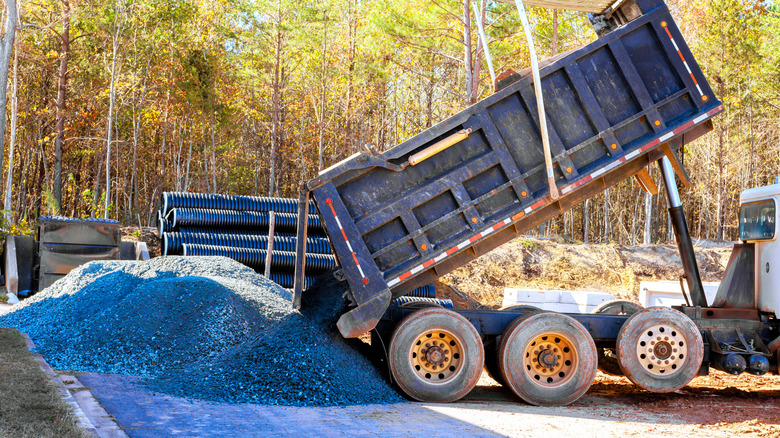 A dump truck delivering gravel