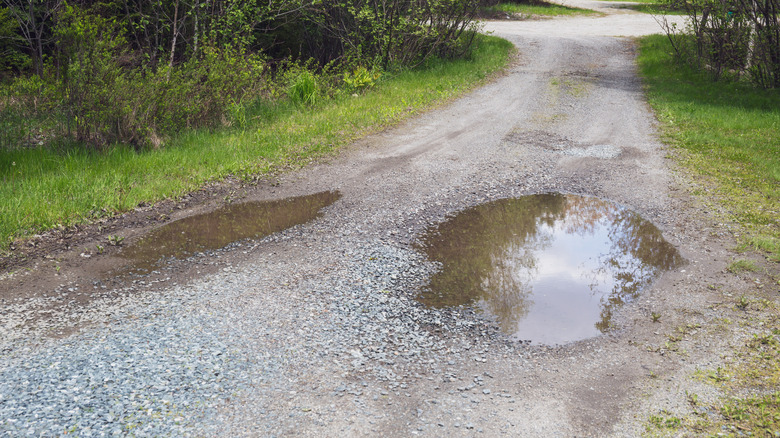 Puddles of water can form on an improperly crowned gravel driveway
