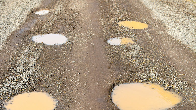 A potholed road in need of new gravel