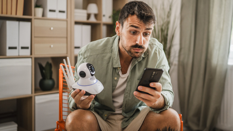 Frustrated man learning how to install a security camera