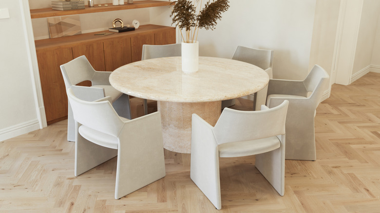 contemporary dining room with a marble table and white chairs