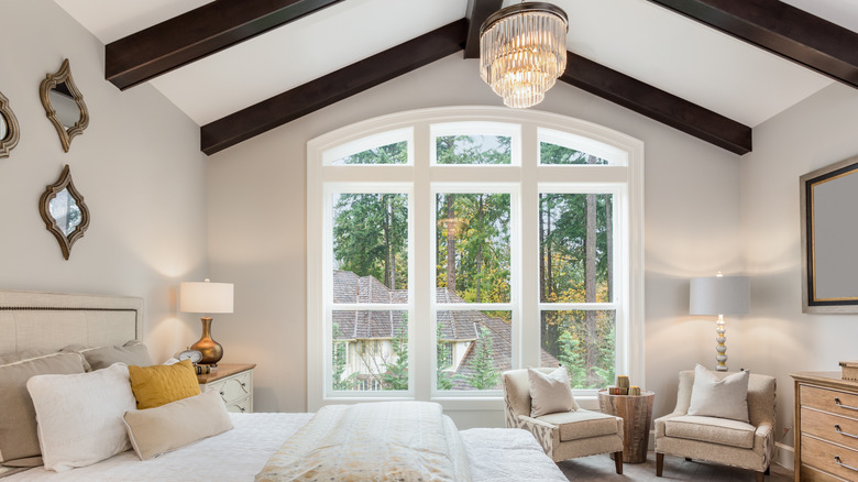 A bedroom with untreated windows
