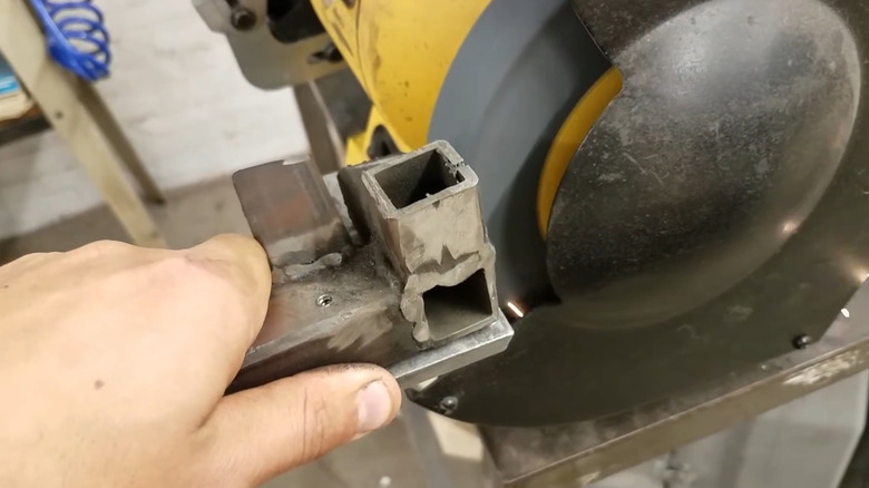 Smoothing a welded bead with a bench grinder