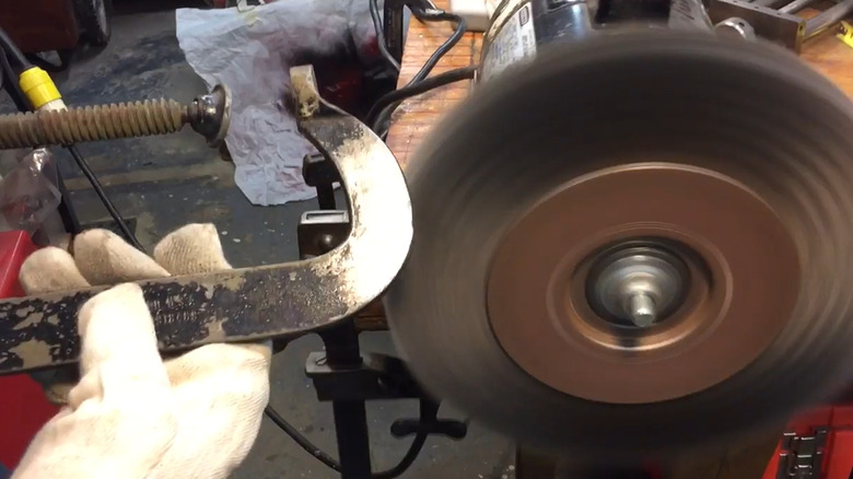 Removing paint with a wire wheel mounted to a bench grinder