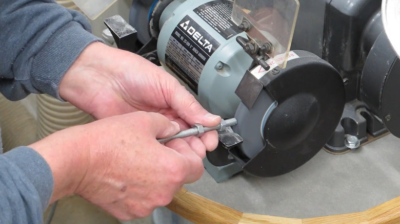 Using a bench grinder to clean up threads of a cut threaded rod