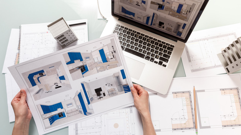 An interior designer working on kitchen designs