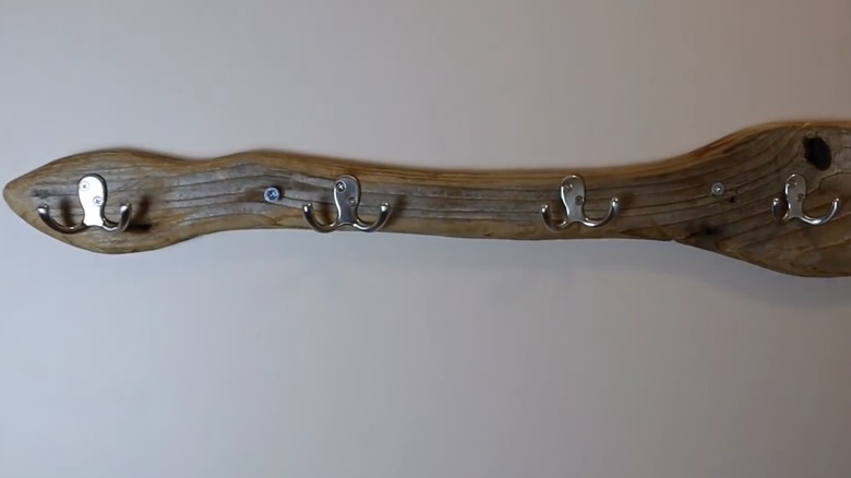 Driftwood rack with hooks mounted on wall