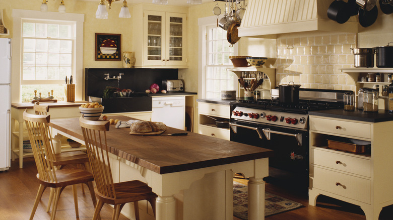 A kitchen making use of freestanding, unfitted cabinetry and other furnishings