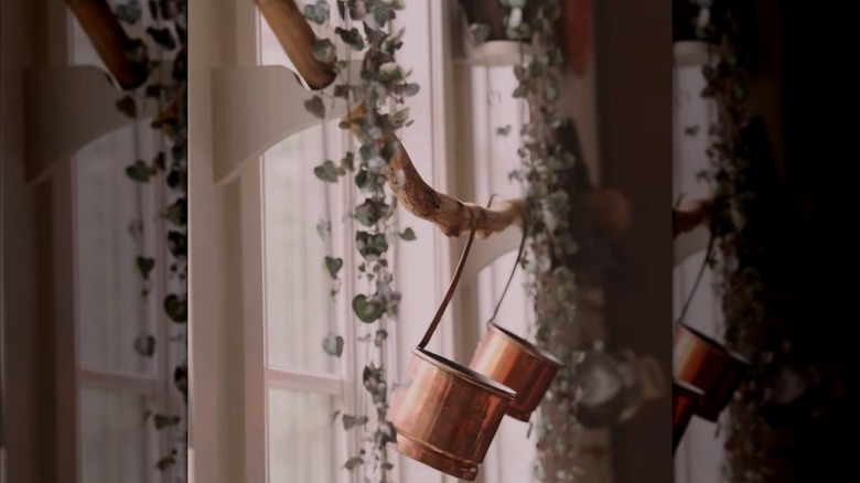 Thrifted curtain brackets and stick turned into storage solution