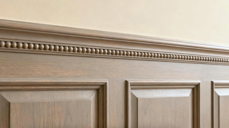 Bobbin trim applied below wainscoting trim