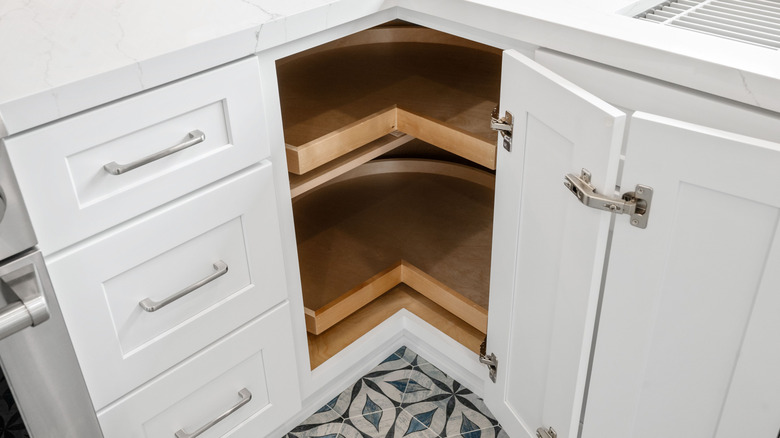 white corner cabinets in a kitchen
