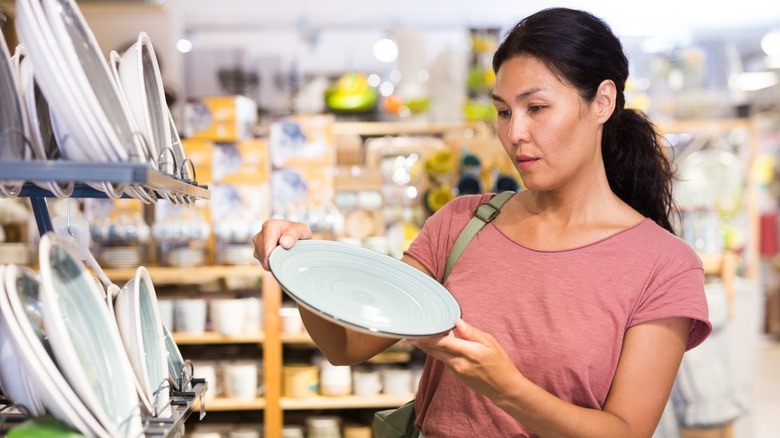 Woman shopping for dinnerware.
