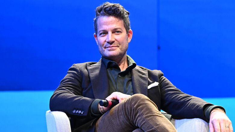 interior designer Nate Berkus sitting in a blue room