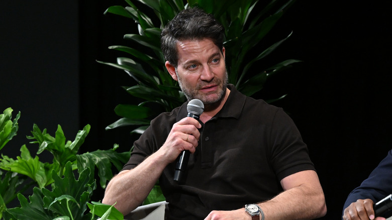 Nate Berkus with microphone at an event.
