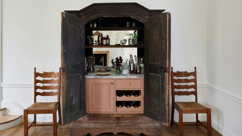 A vintage armoire with a bar inside is featured on designer Nate Berkus's instagram page