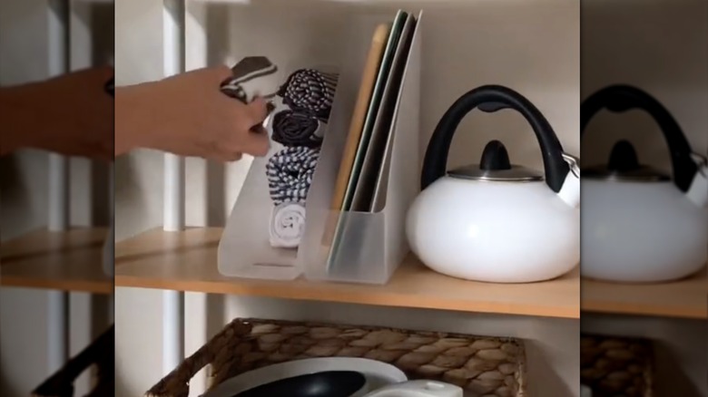 using a magazine file holder to organize rolled kitchen towels