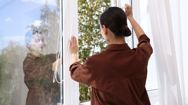 Woman opening windows