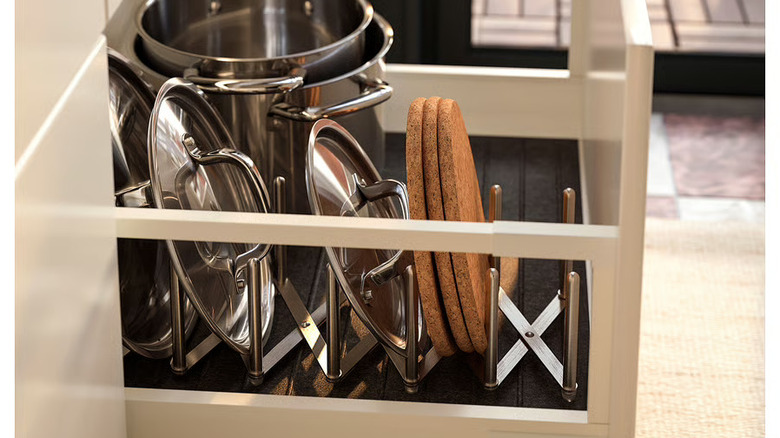 IKEA VARIERA organizer inside a drawer with pot lids and cork trivets stored upright