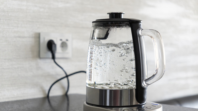 Water boiling in a transparent electric kettle.