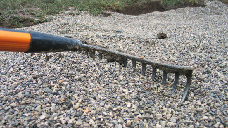 using a hefty rake to move gravel