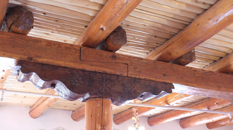 Creative cast shadows from vigas and latillas on exterior adobe wal