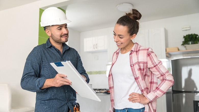 Contractor and homeowner discussing plans for kitchen remodel