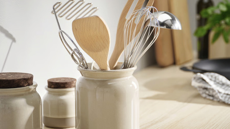 Basic utensil holder sitting on a wood countertop