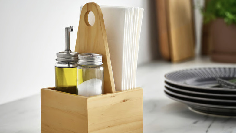 CHOKLADHAJ organizer on a countertop with salt and oil in it