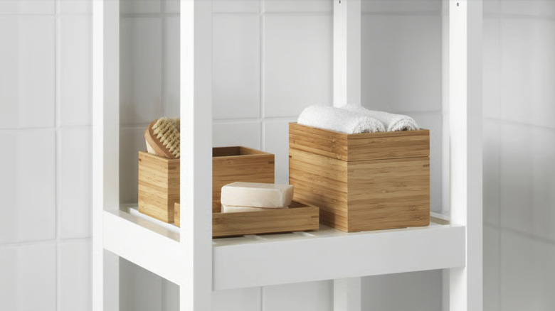 Wooden boxes from IKEA sitting on a bathroom shelf