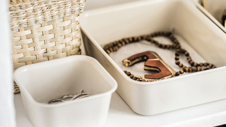 Plastic organizers from IKEA with small personal items in them