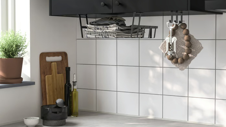 Plastic basket hanging above a stone countertop