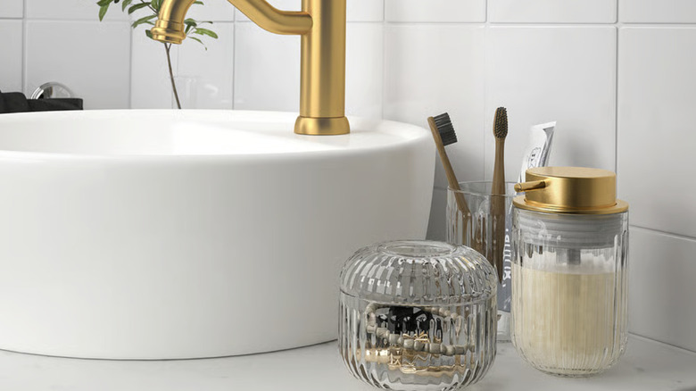 Glass SILVTJÄRN container sitting on a vanity countertop