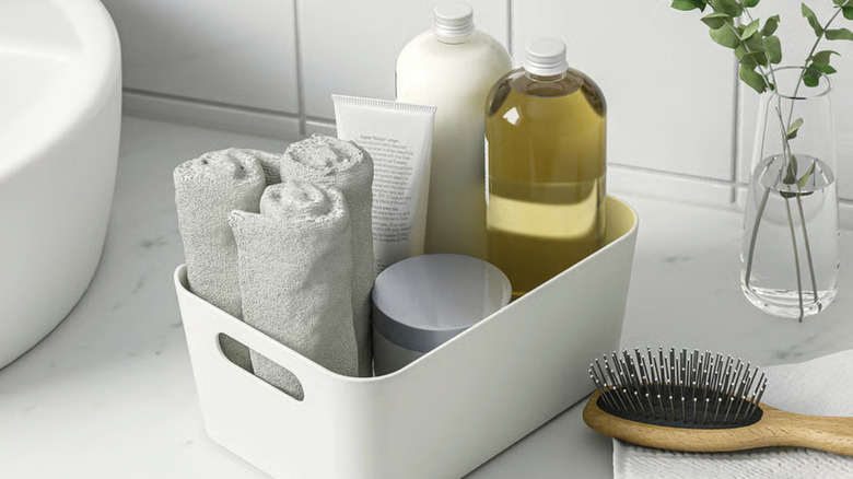 Plastic UPPDATERA box with bathroom supplies in it on a counter