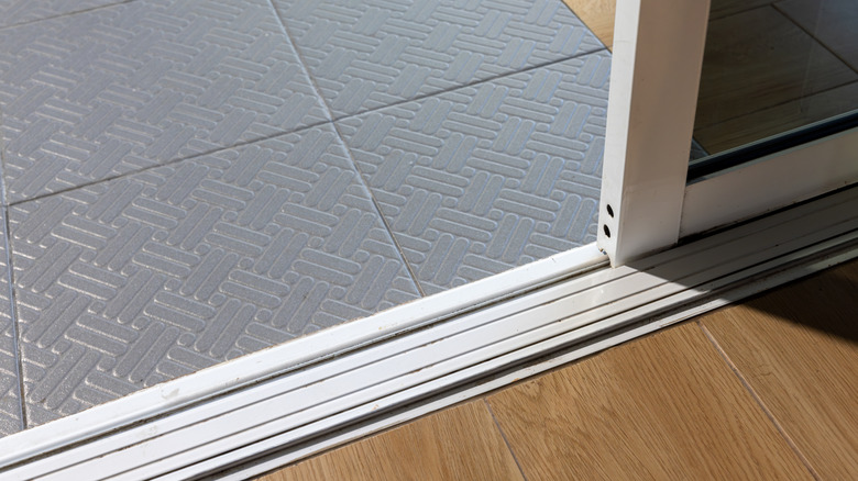 Close-up of dusty sliding glass door tracks