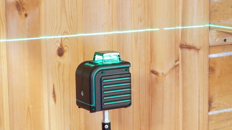 Level line projected across a wood wall