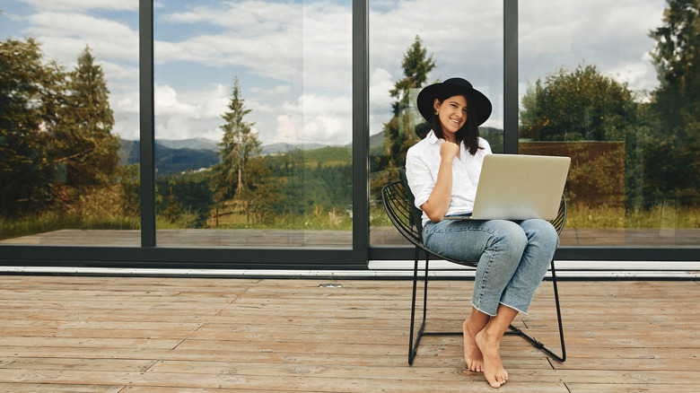 A person shopping online on an open back deck
