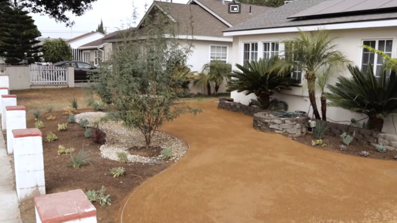 A fully-finished decomposed granite driveway leading to a suburban American home.
